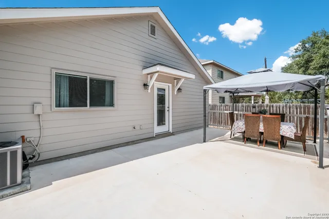 a view of a house with a backyard porch and sitting area