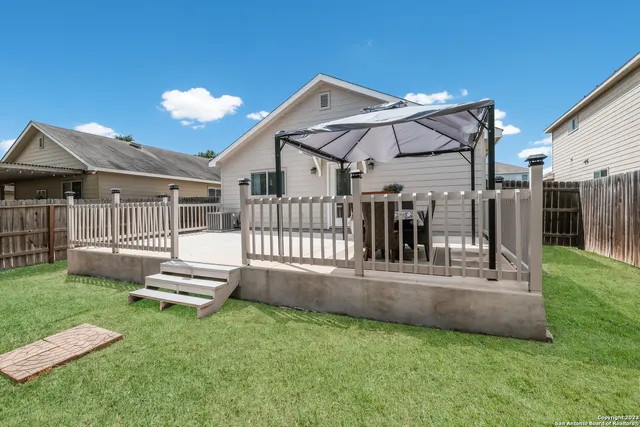 a view of a house with a yard and a garden