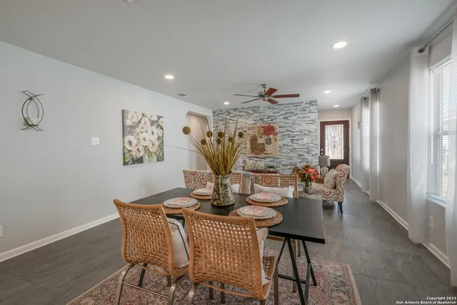 a dining room with furniture and window
