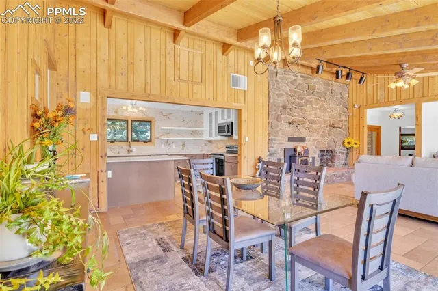 a dining room with furniture and a floor to ceiling window