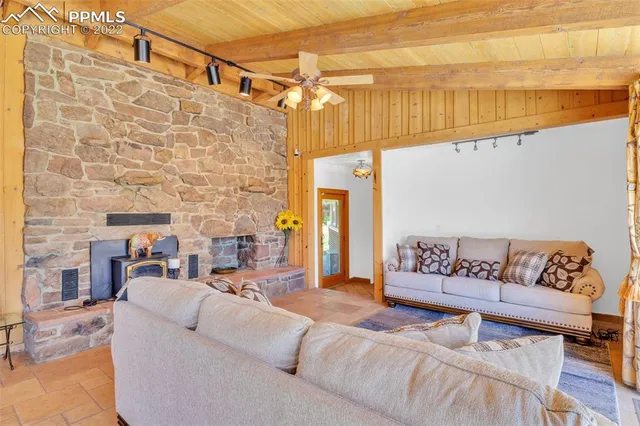 a large kitchen with a sink and dishwasher with a dining table