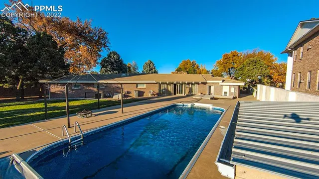 a view of a swimming pool with an outdoor seating