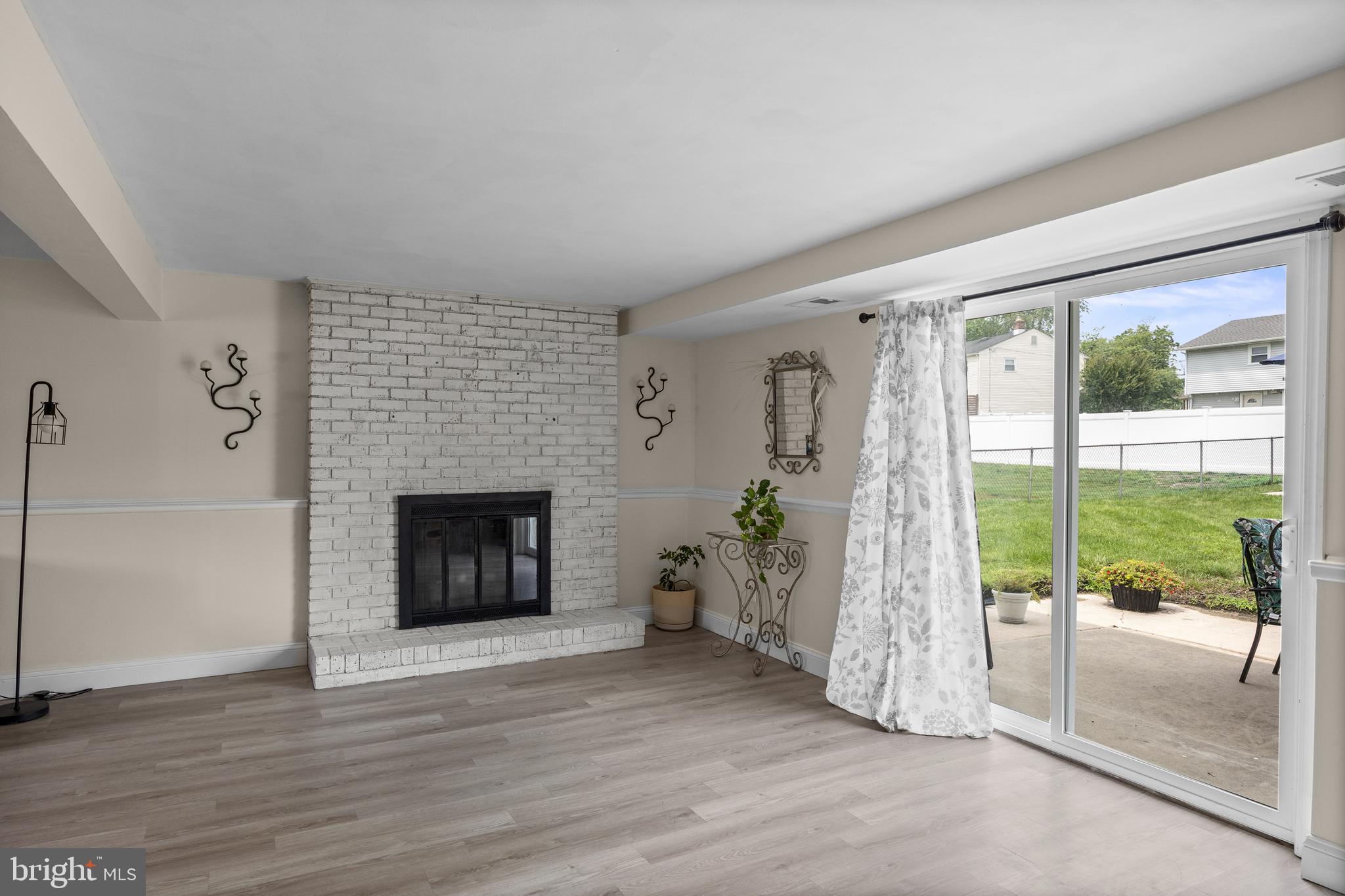 122 Hamilton Road Marlton, NJ 08053 - Photo 18 of 25 a living room with a fireplace and a floor to ceiling window