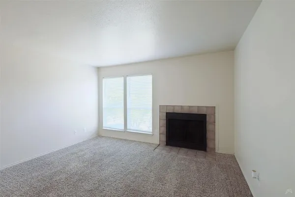 a view of an empty room and a ceiling fan
