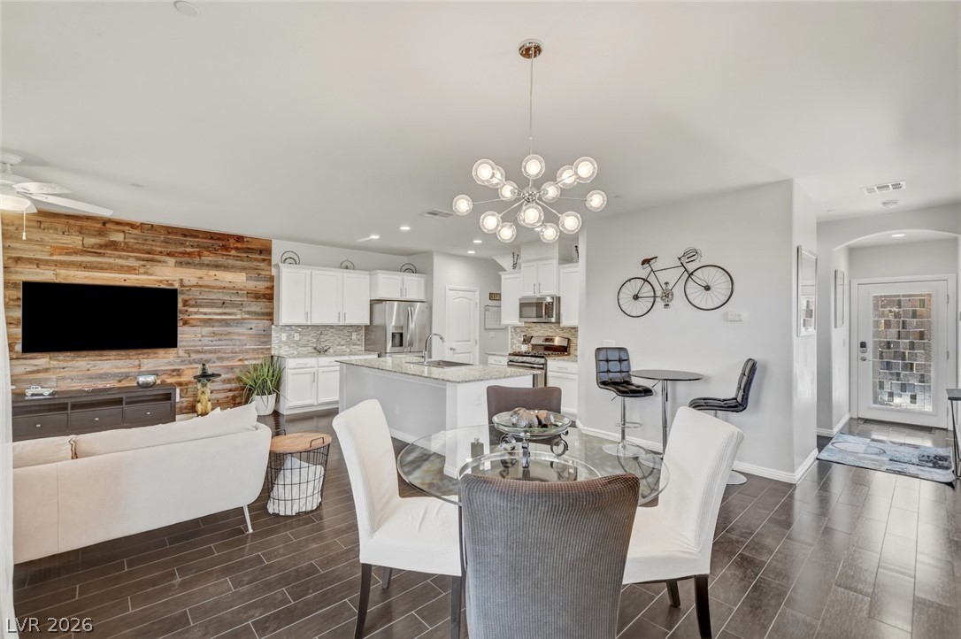 48 Jasmine Point Street Henderson, NV 89074 - Photo 13 of 62 An open concept living area seamlessly blends a contemporary kitchen with a cozy dining and lounge space.