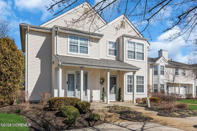 a view of a brick house with large windows