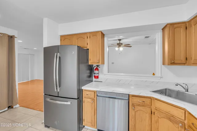 a kitchen with stainless steel appliances granite countertop a refrigerator and a sink