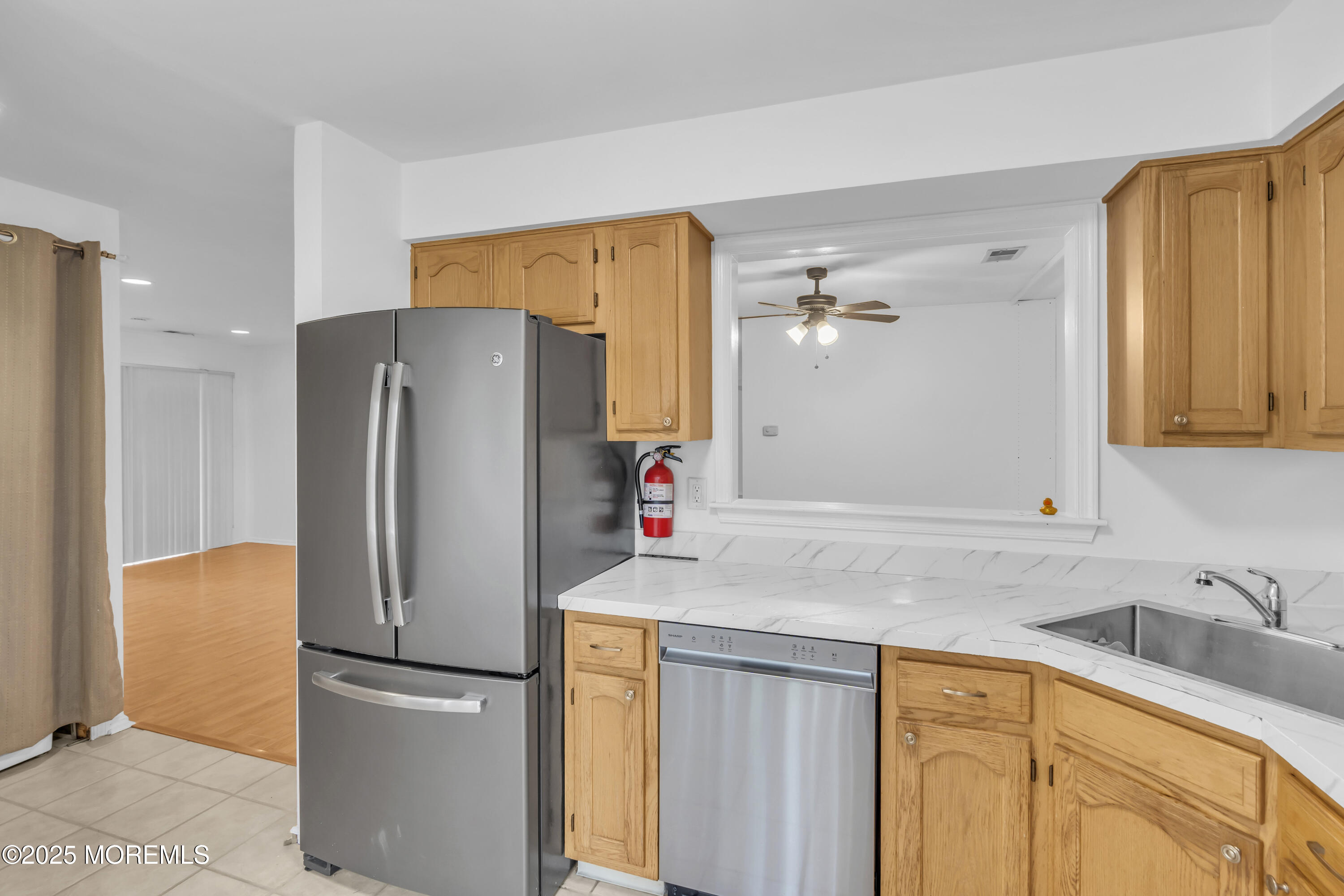 237 Paddington Court, Unit 87 Manalapan, NJ 07726 - Photo 13 of 23 a kitchen with stainless steel appliances granite countertop a refrigerator and a sink