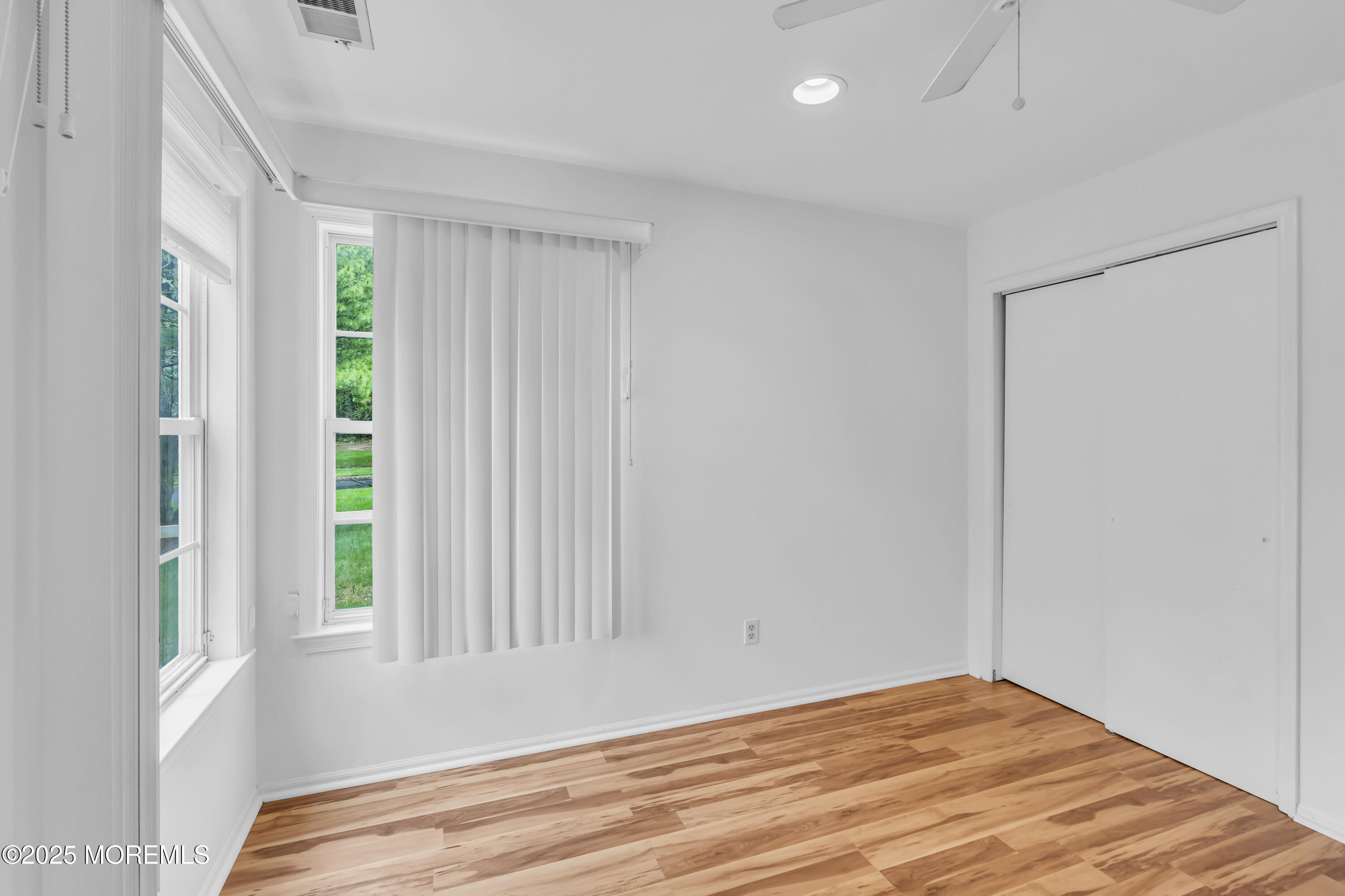237 Paddington Court, Unit 87 Manalapan, NJ 07726 - Photo 15 of 23 a view of wooden floor and windows in a room