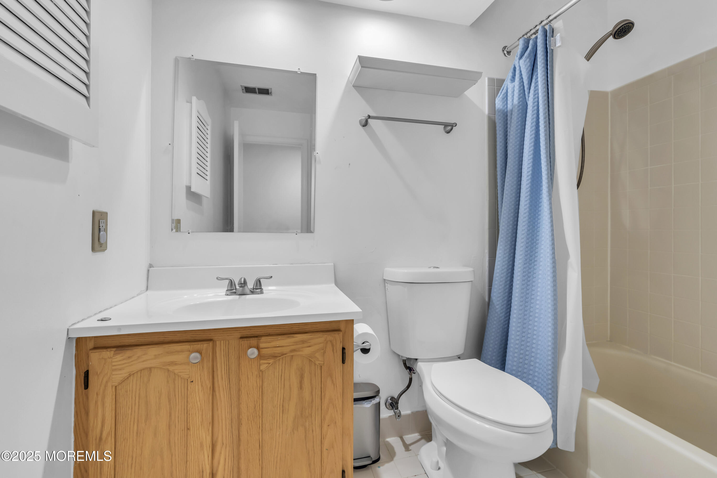 237 Paddington Court, Unit 87 Manalapan, NJ 07726 - Photo 16 of 23 a white toilet sitting next to a bathroom sink