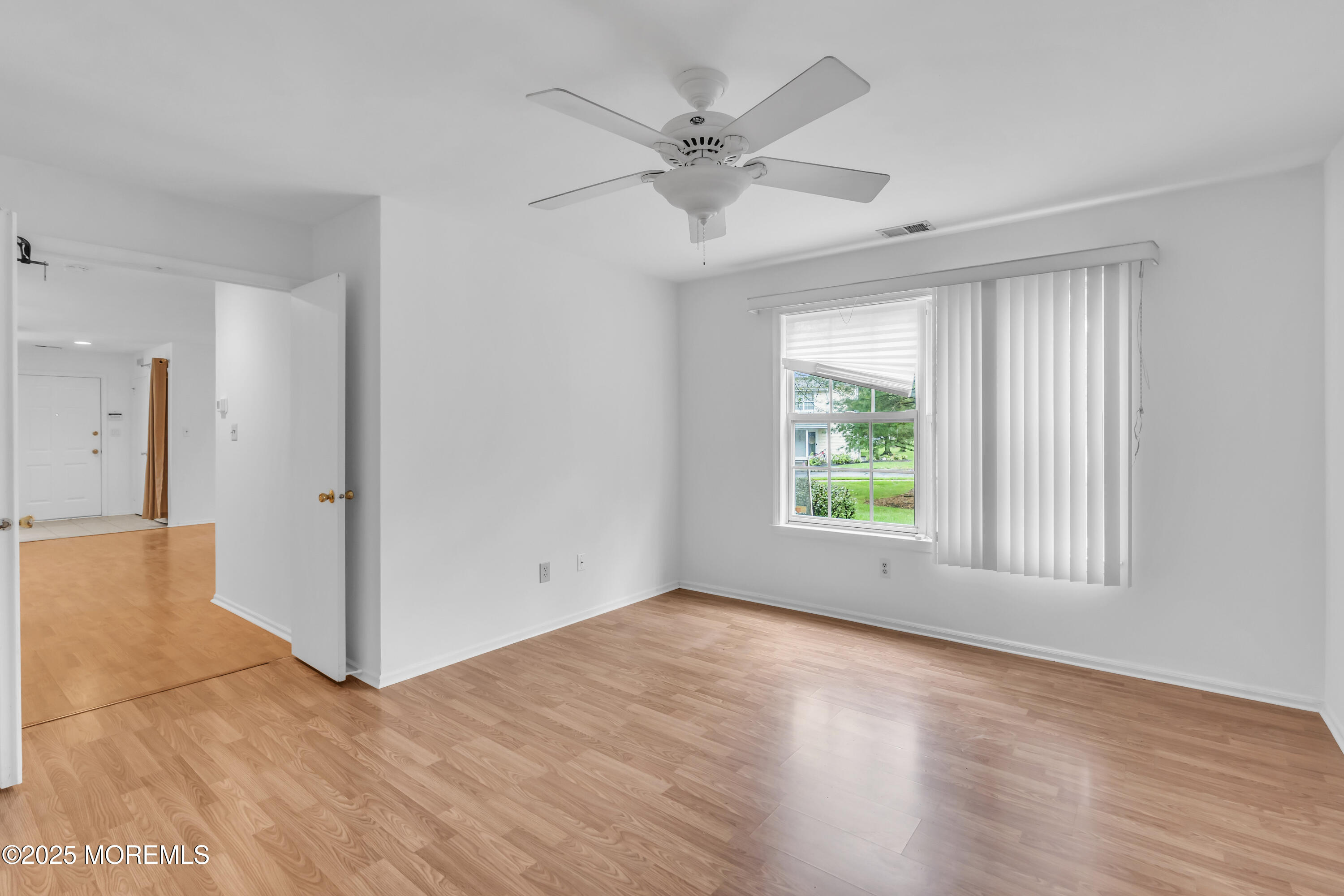237 Paddington Court, Unit 87 Manalapan, NJ 07726 - Photo 18 of 23 wooden floor in an empty room with a window