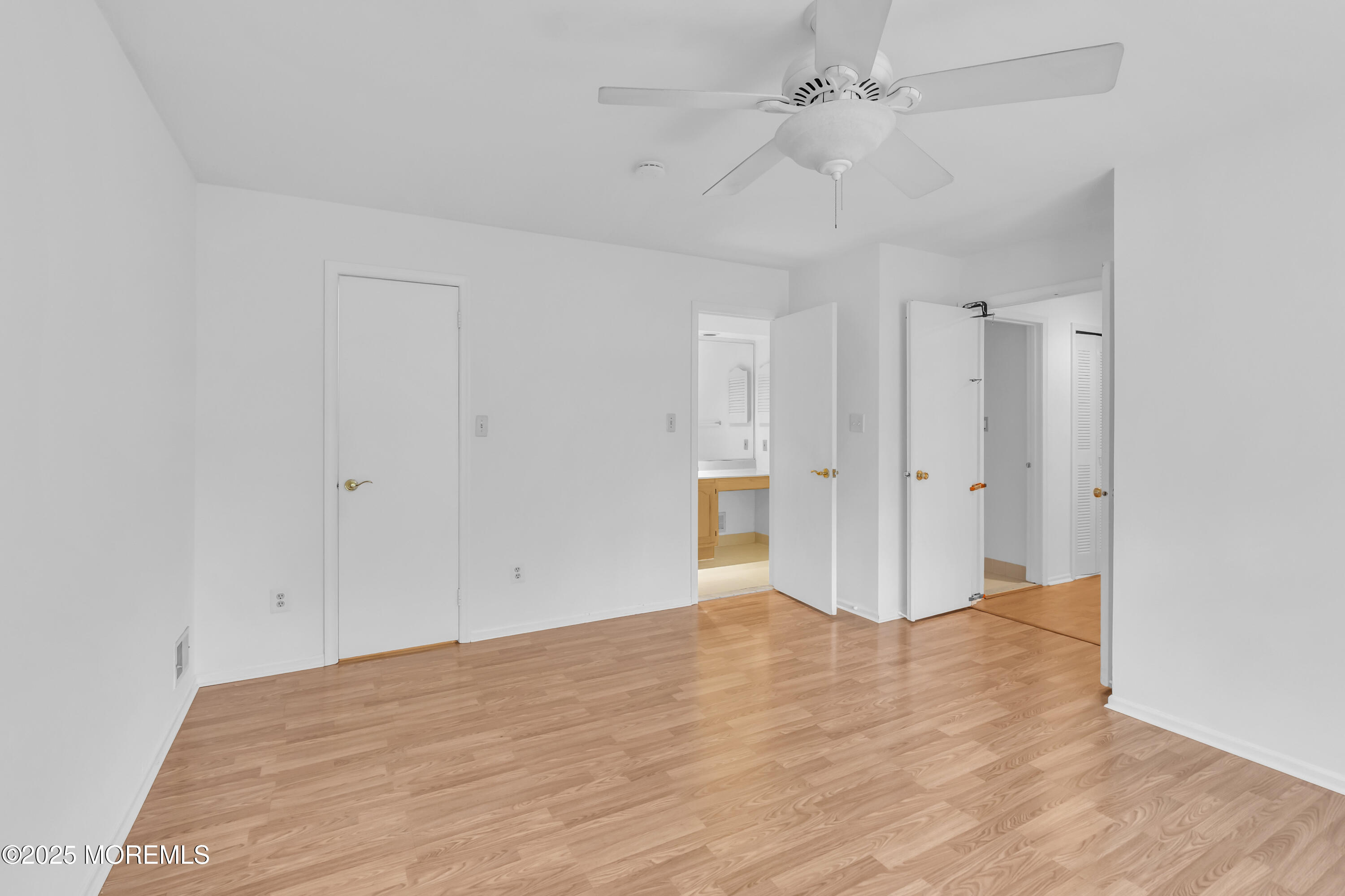 237 Paddington Court, Unit 87 Manalapan, NJ 07726 - Photo 19 of 23 a view of empty room with wooden floor