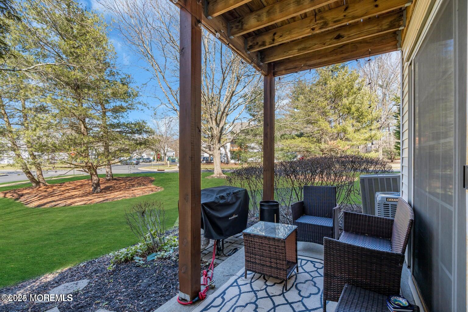 237 Paddington Court, Unit 87 Manalapan, NJ 07726 - Photo 22 of 23 a view of a patio with couches chairs and a yard