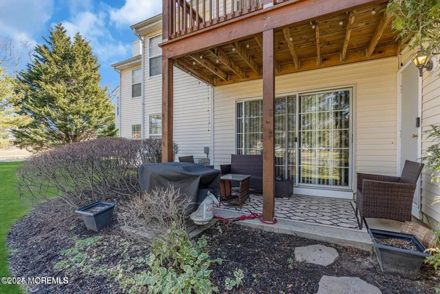 a view of a chair and table in backyard