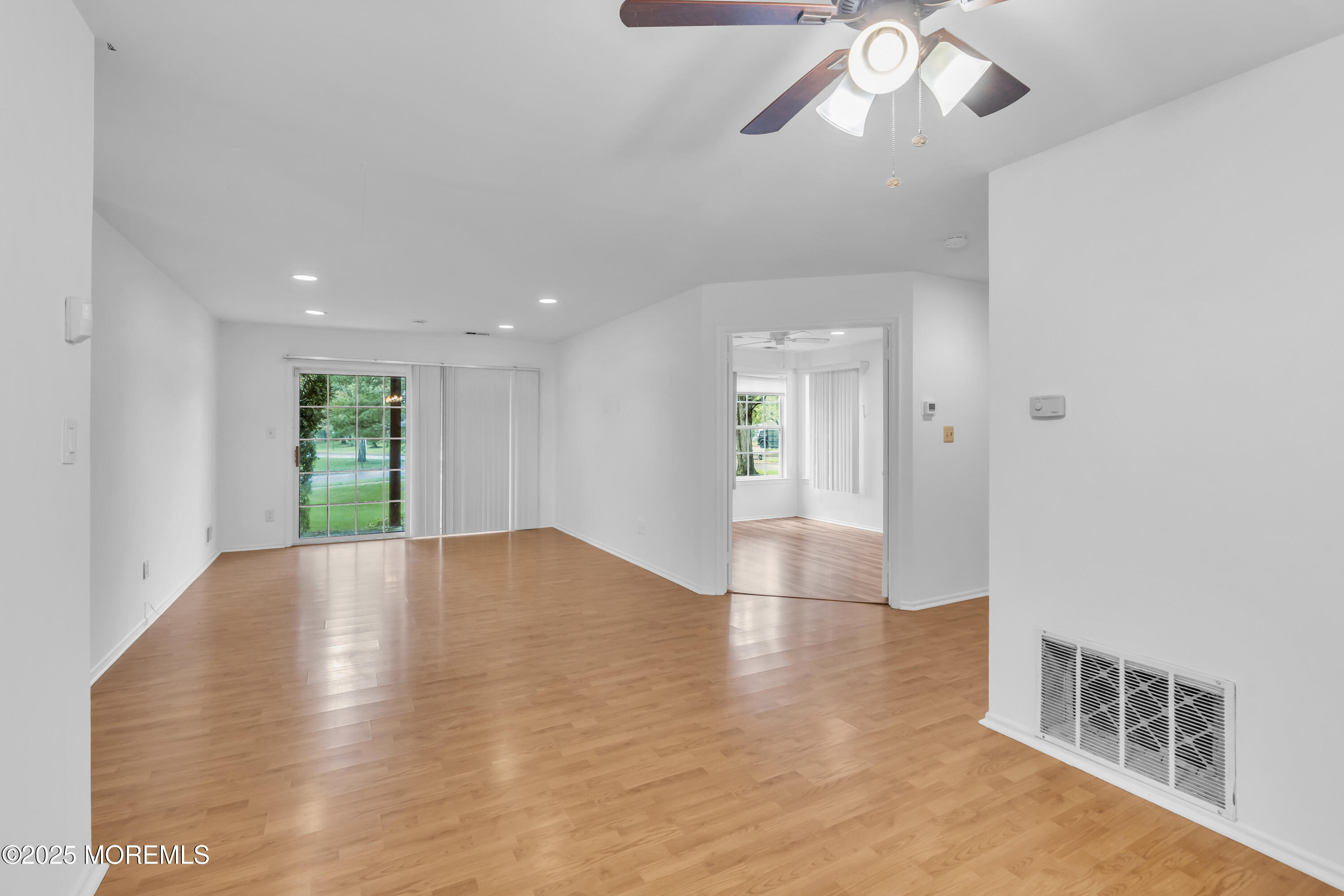 237 Paddington Court, Unit 87 Manalapan, NJ 07726 - Photo 4 of 23 a view of empty room with wooden floor