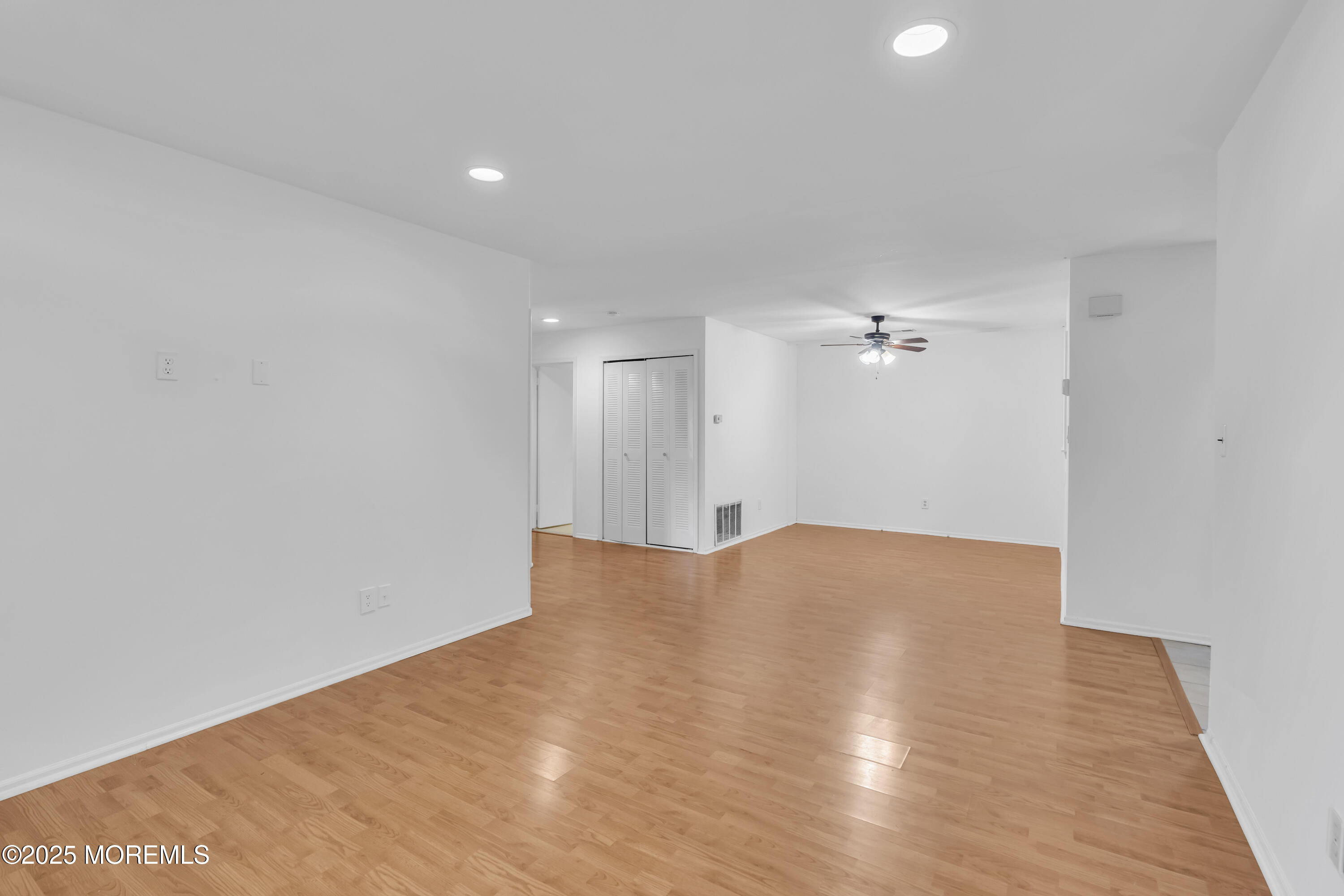 237 Paddington Court, Unit 87 Manalapan, NJ 07726 - Photo 6 of 23 a view of empty room with wooden floor