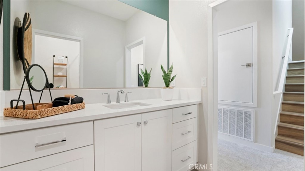 348 Mulberry Place Montebello, CA 90640 - Photo 24 of 39 a bathroom with a granite countertop sink and a mirror