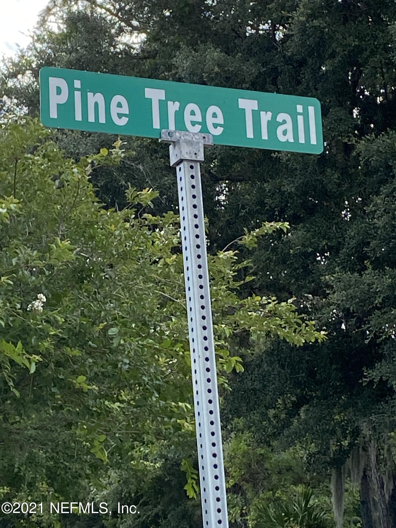 a sign broad in front of the tree