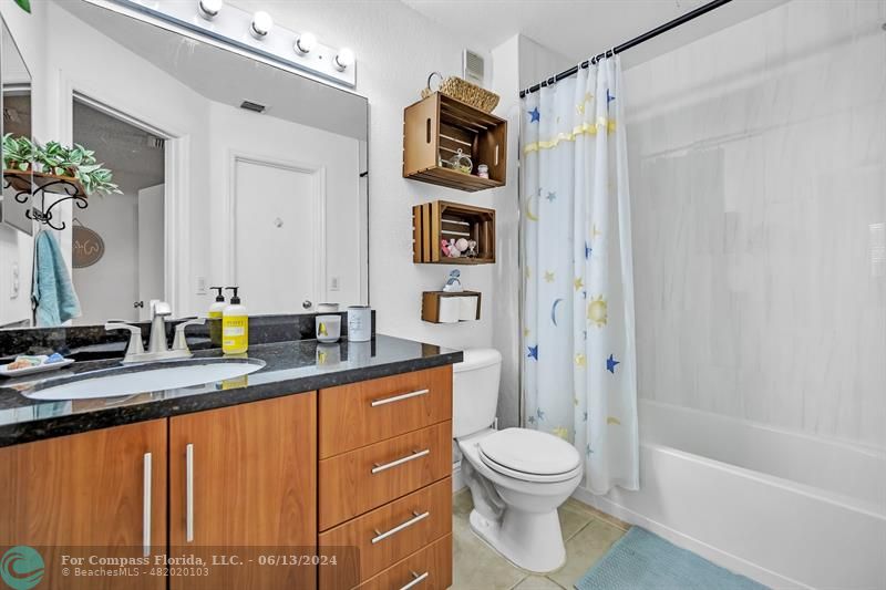 3410 Pinewalk Drive North, Unit 812 Pompano Beach, FL 33063 - Photo 16 of 26 a bathroom with a granite countertop sink toilet and shower