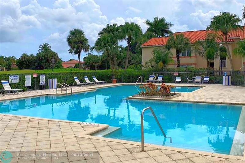 3410 Pinewalk Drive North, Unit 812 Pompano Beach, FL 33063 - Photo 18 of 26 a view of a swimming pool with lounge chair