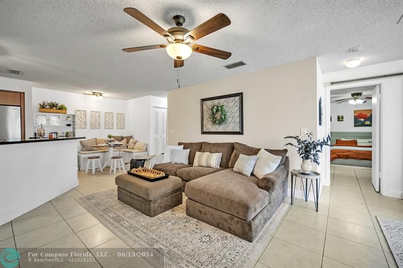 3410 Pinewalk Drive North, Unit 812 Pompano Beach, FL 33063 - Photo 3 of 26 a living room with furniture and a large window