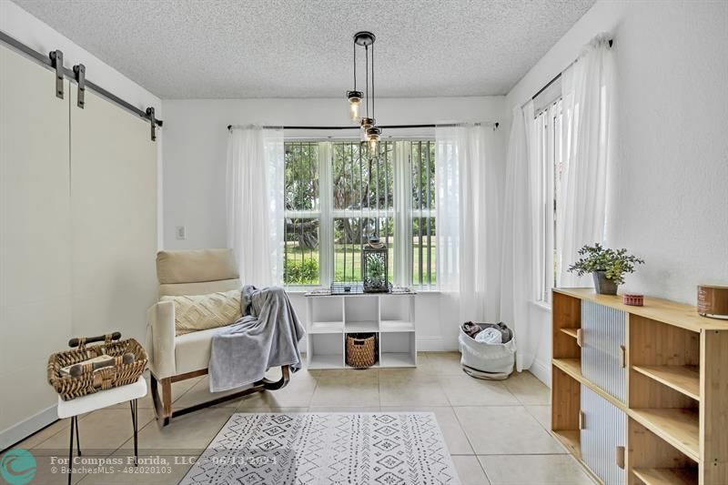3410 Pinewalk Drive North, Unit 812 Pompano Beach, FL 33063 - Photo 5 of 26 a living room with furniture and a window