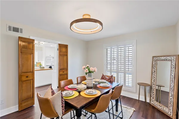 a dining room with furniture and wooden floor