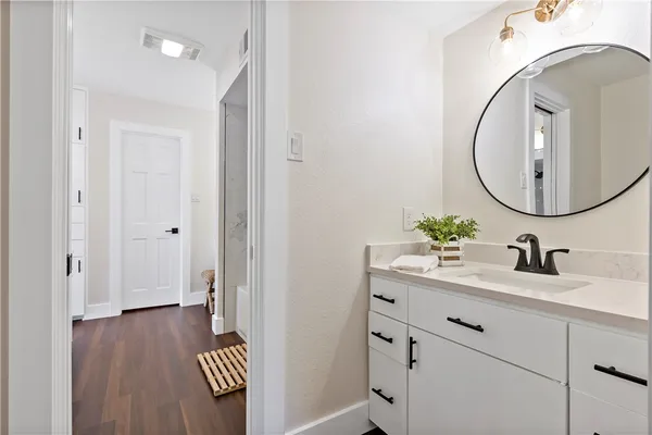 a bathroom with a sink and a mirror