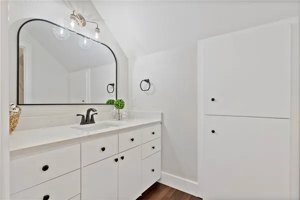 a bathroom with a double vanity sink and mirror