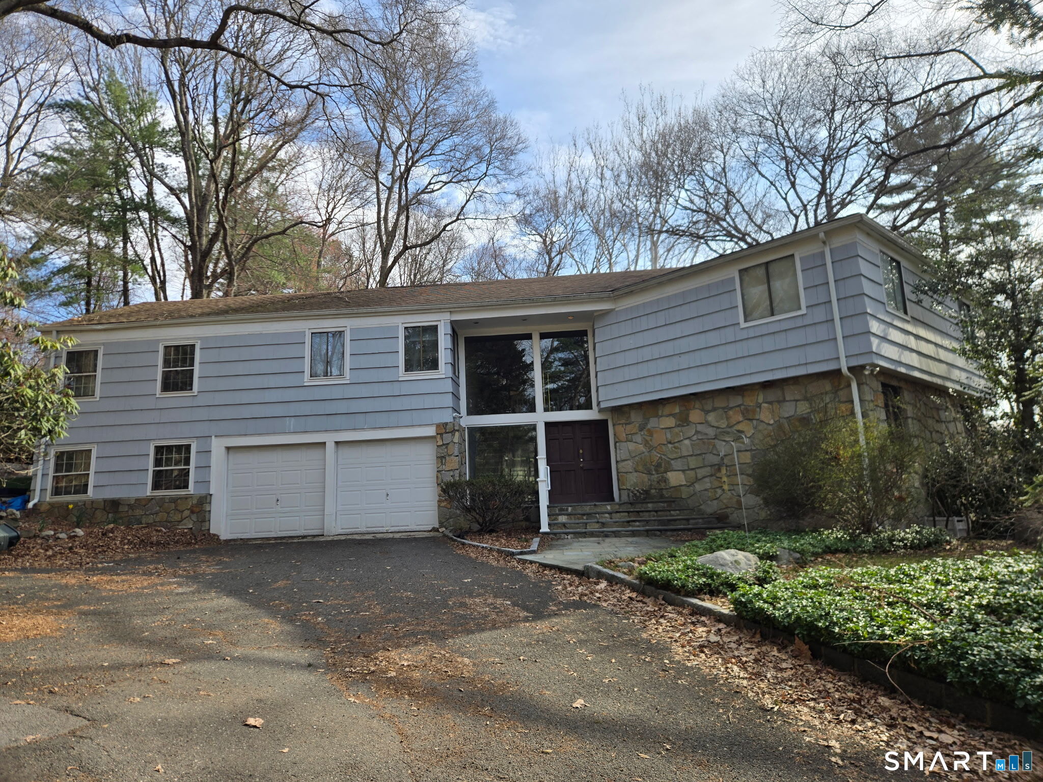 677 West Hill Road Stamford, CT 06902 - Photo 1 of 28 a front view of a house with a yard and garage