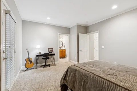 a bedroom with a bed and a chair