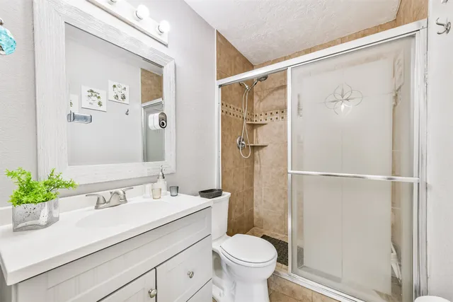 a bathroom with a sink toilet and shower