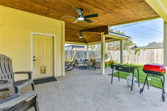 a view of a patio with a table and chairs