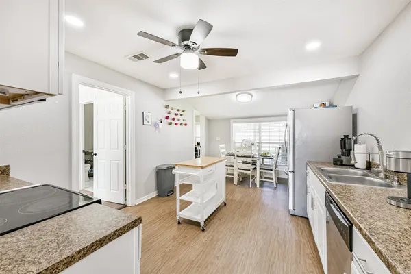 a view of a kitchen with sink and wooden floor