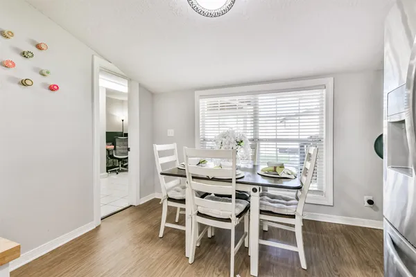 a dining room with furniture and wooden floor