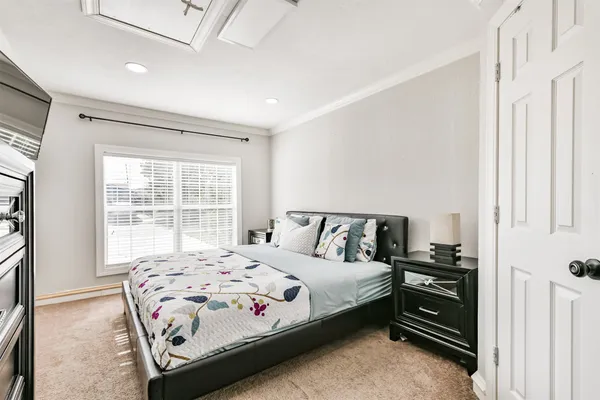 a bedroom with a bed and a window