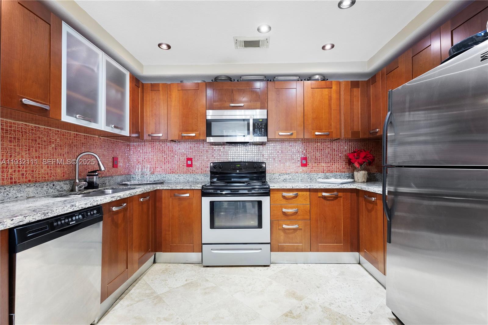 929 Southwest 11th Street, Unit H2 Miami, FL 33129 - Photo 11 of 46 a kitchen with stainless steel appliances granite countertop a sink stove and cabinets