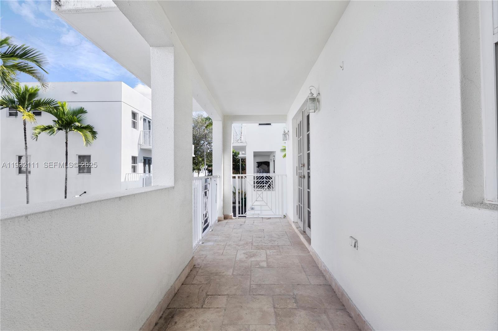 929 Southwest 11th Street, Unit H2 Miami, FL 33129 - Photo 17 of 46 a view of a hallway with wooden floor and a potted plant