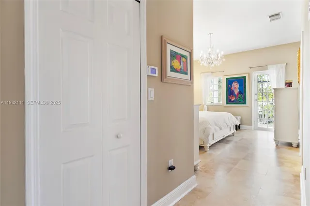 a bedroom with bed and a chandelier