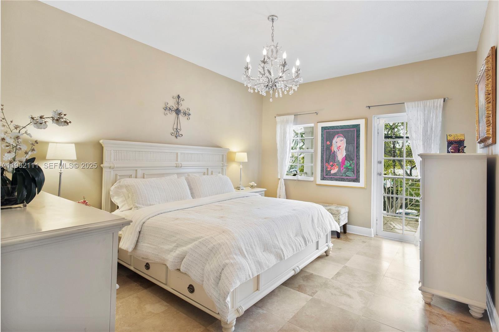 929 Southwest 11th Street, Unit H2 Miami, FL 33129 - Photo 23 of 46 a bedroom with bed and a chandelier