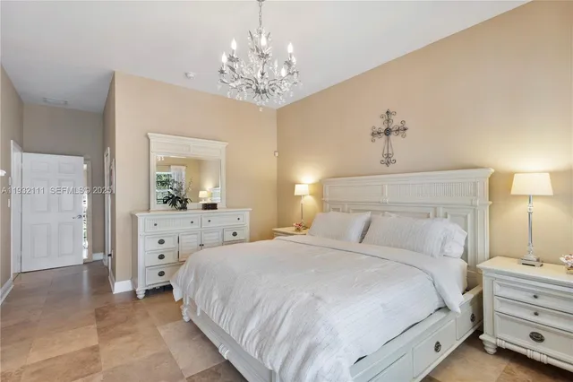 a bedroom with a large bed and a window