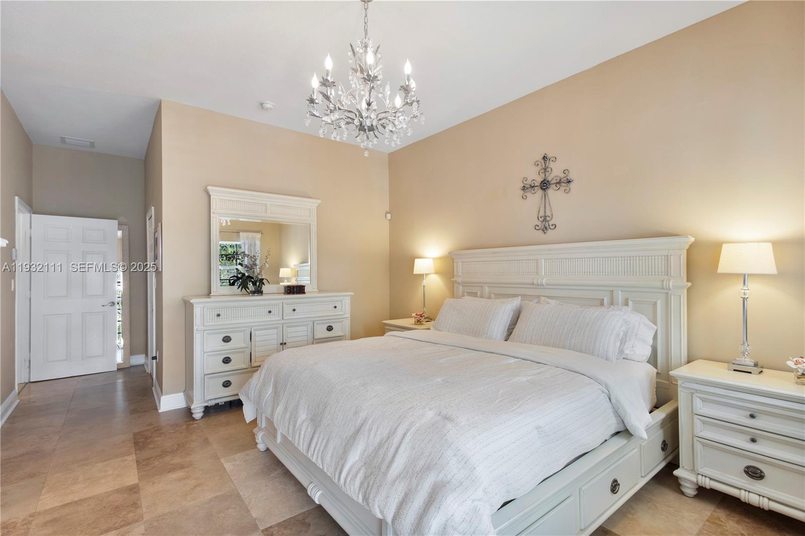 929 Southwest 11th Street, Unit H2 Miami, FL 33129 - Photo 24 of 46 a bedroom with a large bed and a chandelier