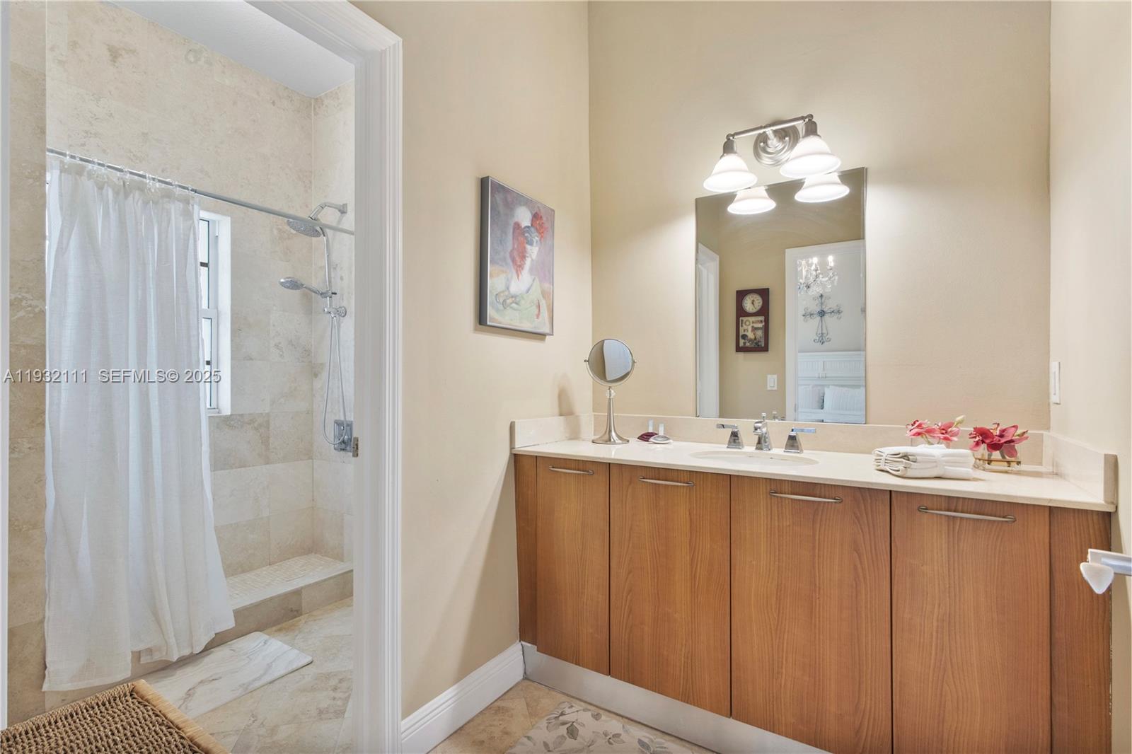 929 Southwest 11th Street, Unit H2 Miami, FL 33129 - Photo 26 of 46 a bathroom with a sink mirror and a shower