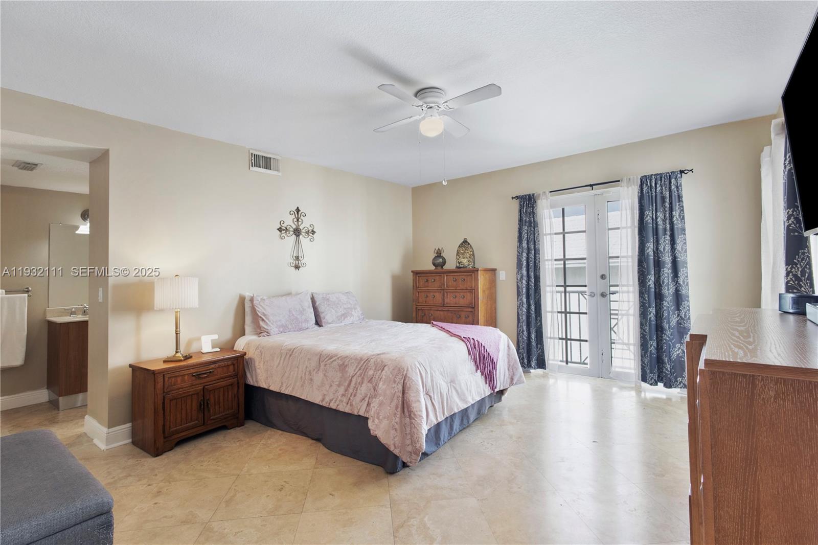 929 Southwest 11th Street, Unit H2 Miami, FL 33129 - Photo 31 of 46 a bedroom with a large bed and a chandelier