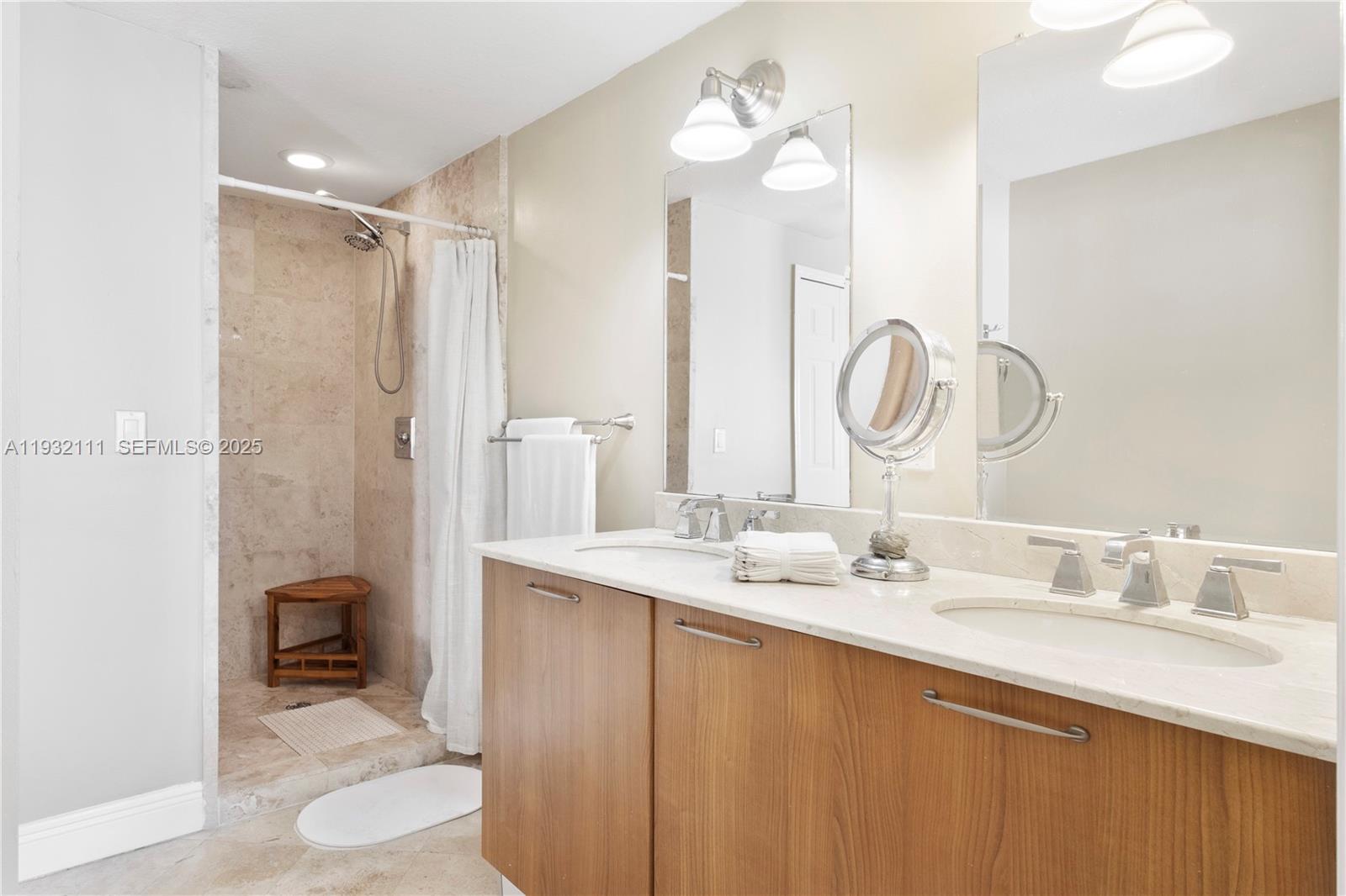 929 Southwest 11th Street, Unit H2 Miami, FL 33129 - Photo 33 of 46 a bathroom with a double vanity sink and a mirror