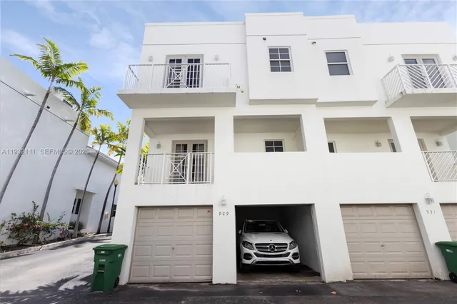 an aerial view of a house with a backyard
