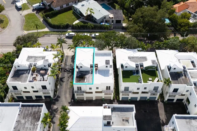 an aerial view of residential houses with city view