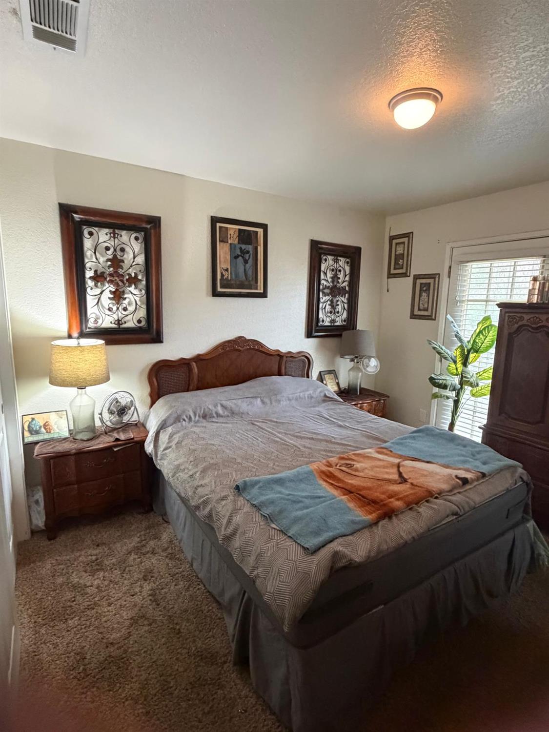 5109 Center Avenue Modesto, CA 95357 - Photo 12 of 45 a bedroom with a bed and dresser