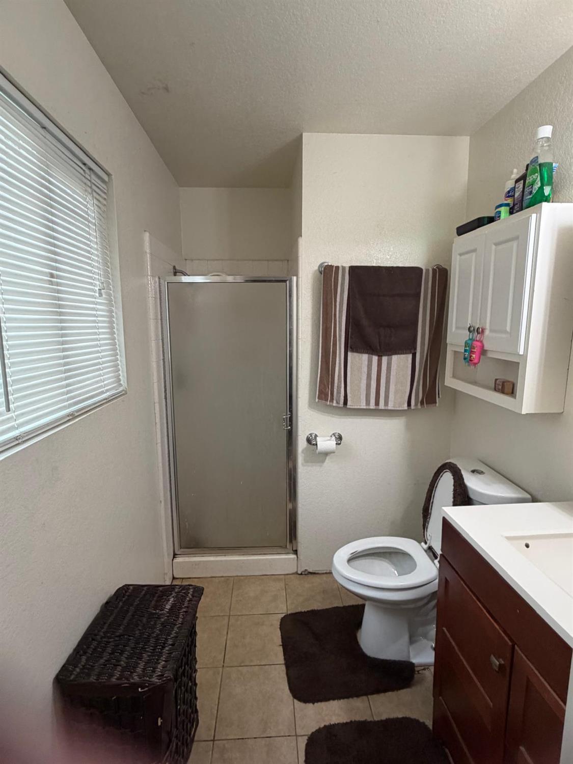 5109 Center Avenue Modesto, CA 95357 - Photo 14 of 45 a bathroom with a toilet a sink and a mirror
