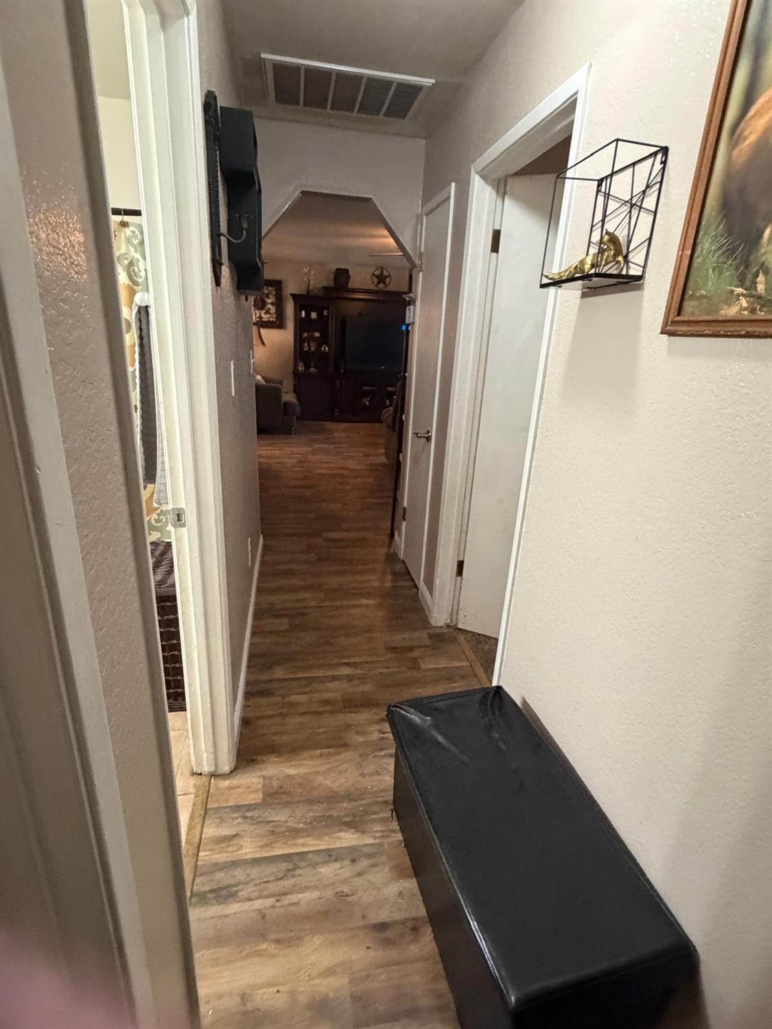 5109 Center Avenue Modesto, CA 95357 - Photo 19 of 45 a view of a hallway with wooden floor and staircase